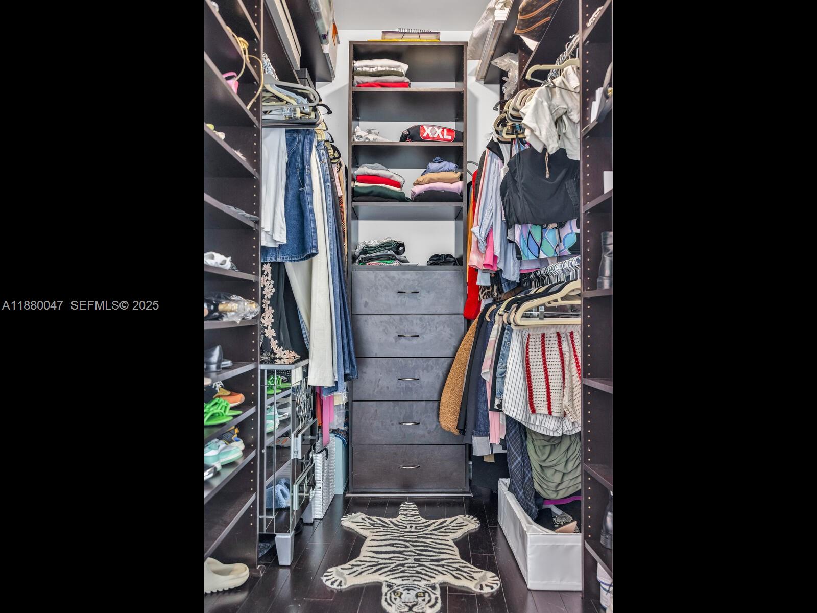 601 Northeast 36th Street, Unit 1304 Miami, FL 33137 - Photo 32 of 40 a view of walk in closet with clothes