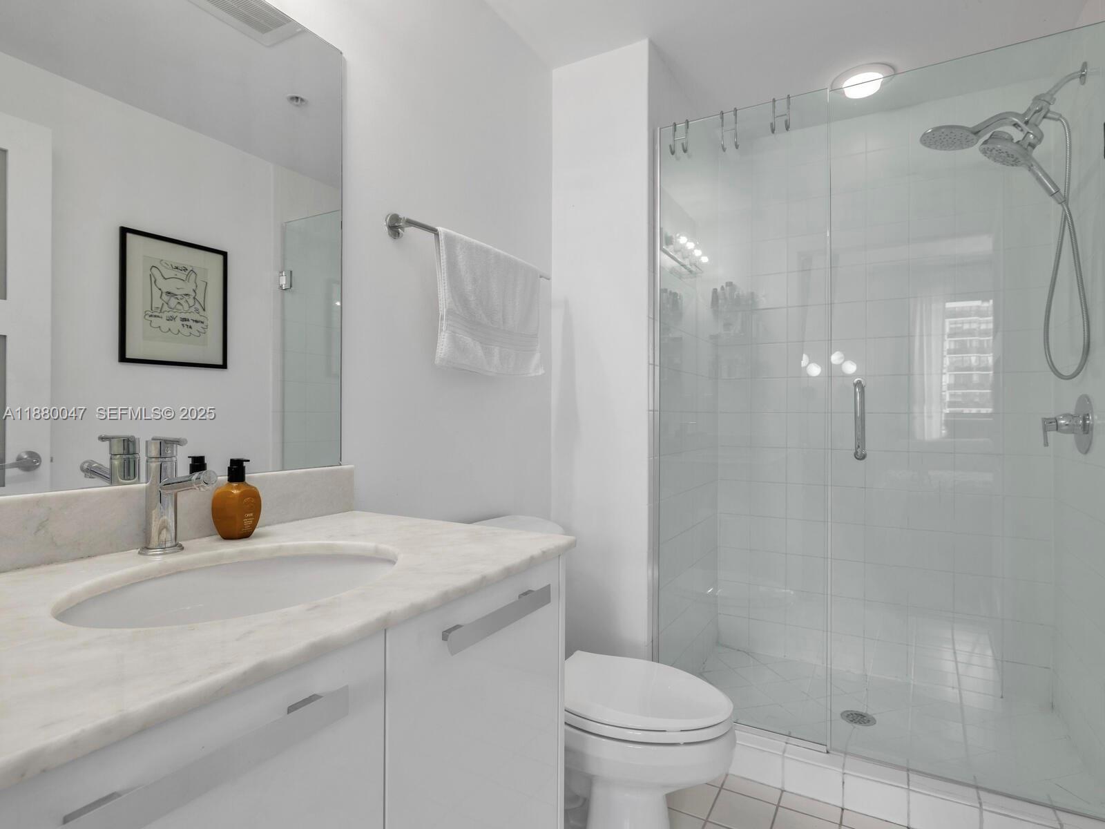 601 Northeast 36th Street, Unit 1304 Miami, FL 33137 - Photo 35 of 40 a bathroom with a sink toilet and shower