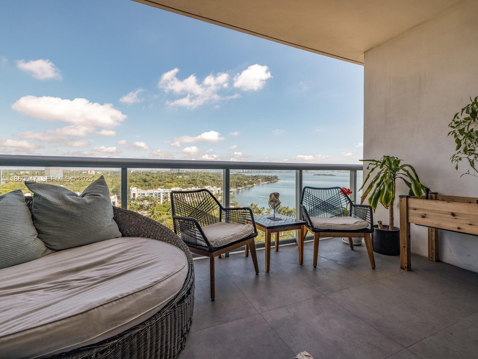 601 Northeast 36th Street, Unit 1304 Miami, FL 33137 - Photo 4 of 40 a bedroom with furniture and a potted plant