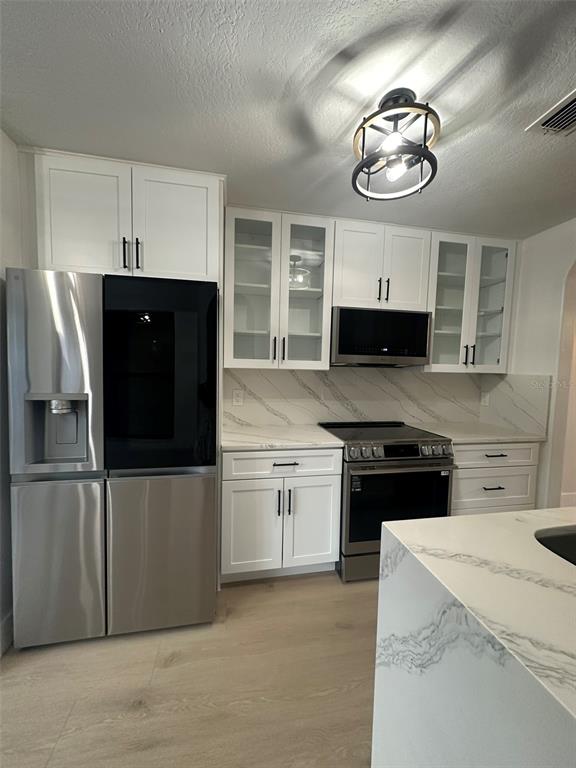 706 Lighthouse Court Altamonte Springs, FL 32714 - Photo 40 of 64 a kitchen with stainless steel appliances granite countertop a refrigerator a stove a sink and dishwasher
