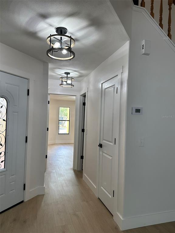 706 Lighthouse Court Altamonte Springs, FL 32714 - Photo 60 of 64 a view of a hallway with windows and chandelier