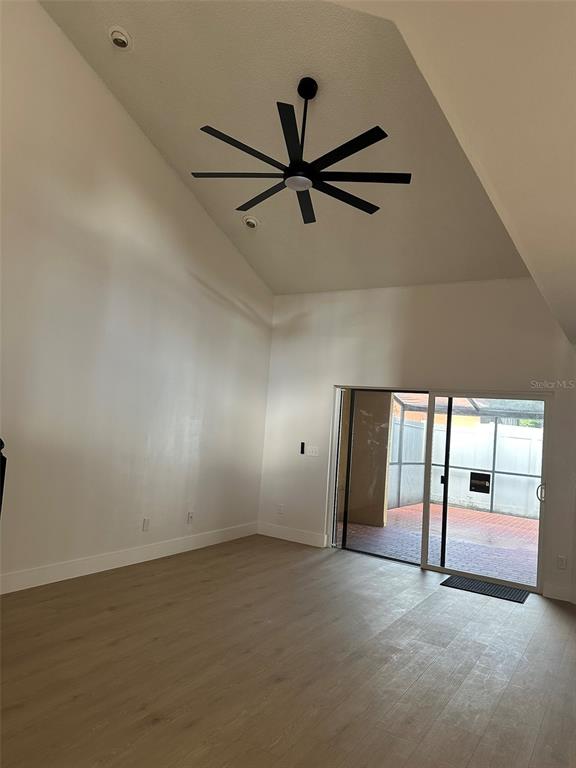 706 Lighthouse Court Altamonte Springs, FL 32714 - Photo 10 of 64 an empty room with windows and way to kitchen