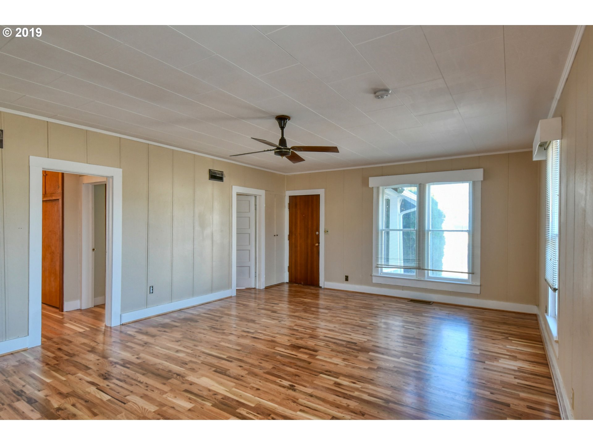 1008 Southwest Frazer Avenue Pendleton, OR 97801 - Photo 4 of 32 a view of an empty room with wooden floor and a window