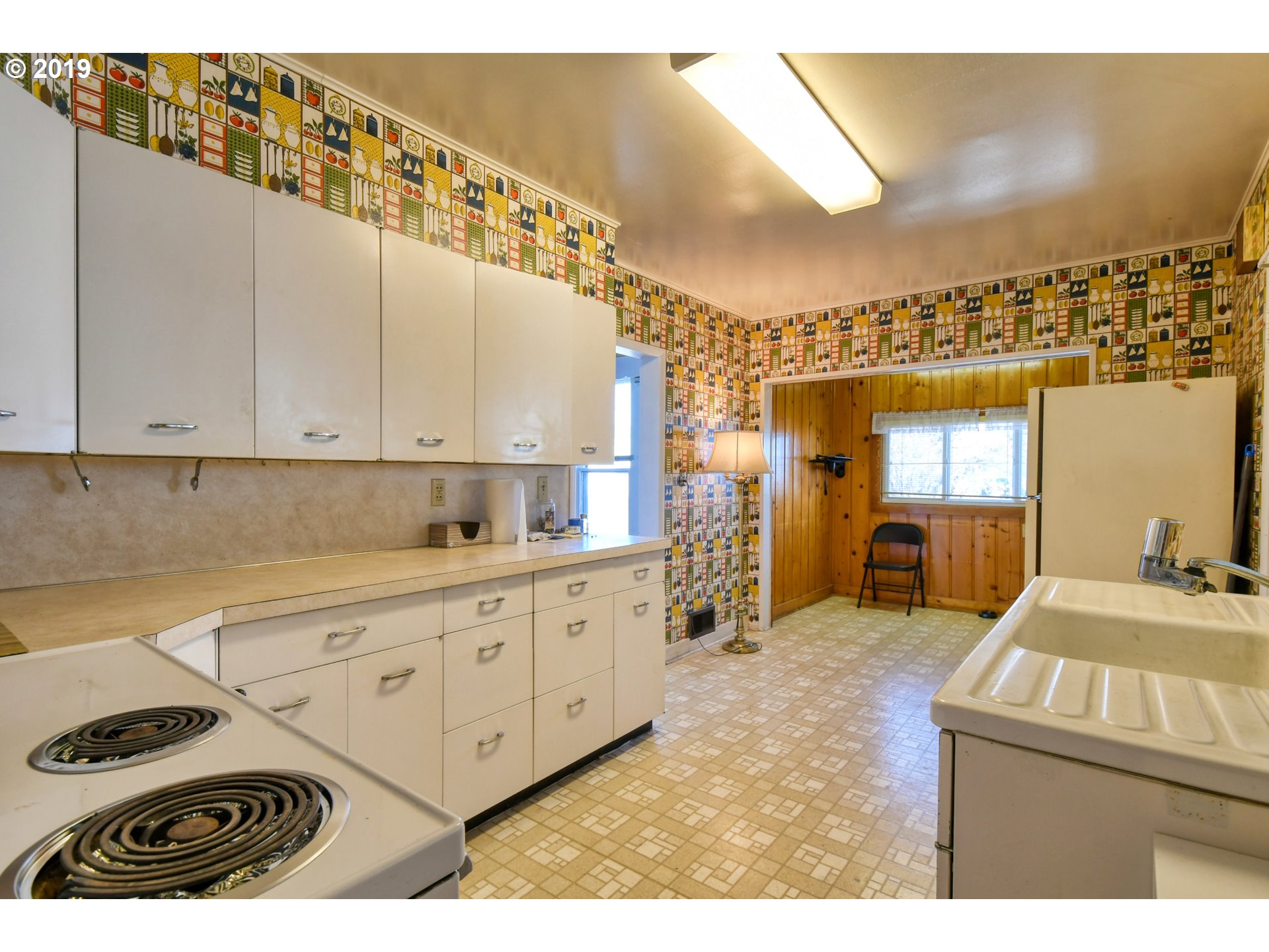 1008 Southwest Frazer Avenue Pendleton, OR 97801 - Photo 6 of 32 a kitchen with a sink stove and cabinets