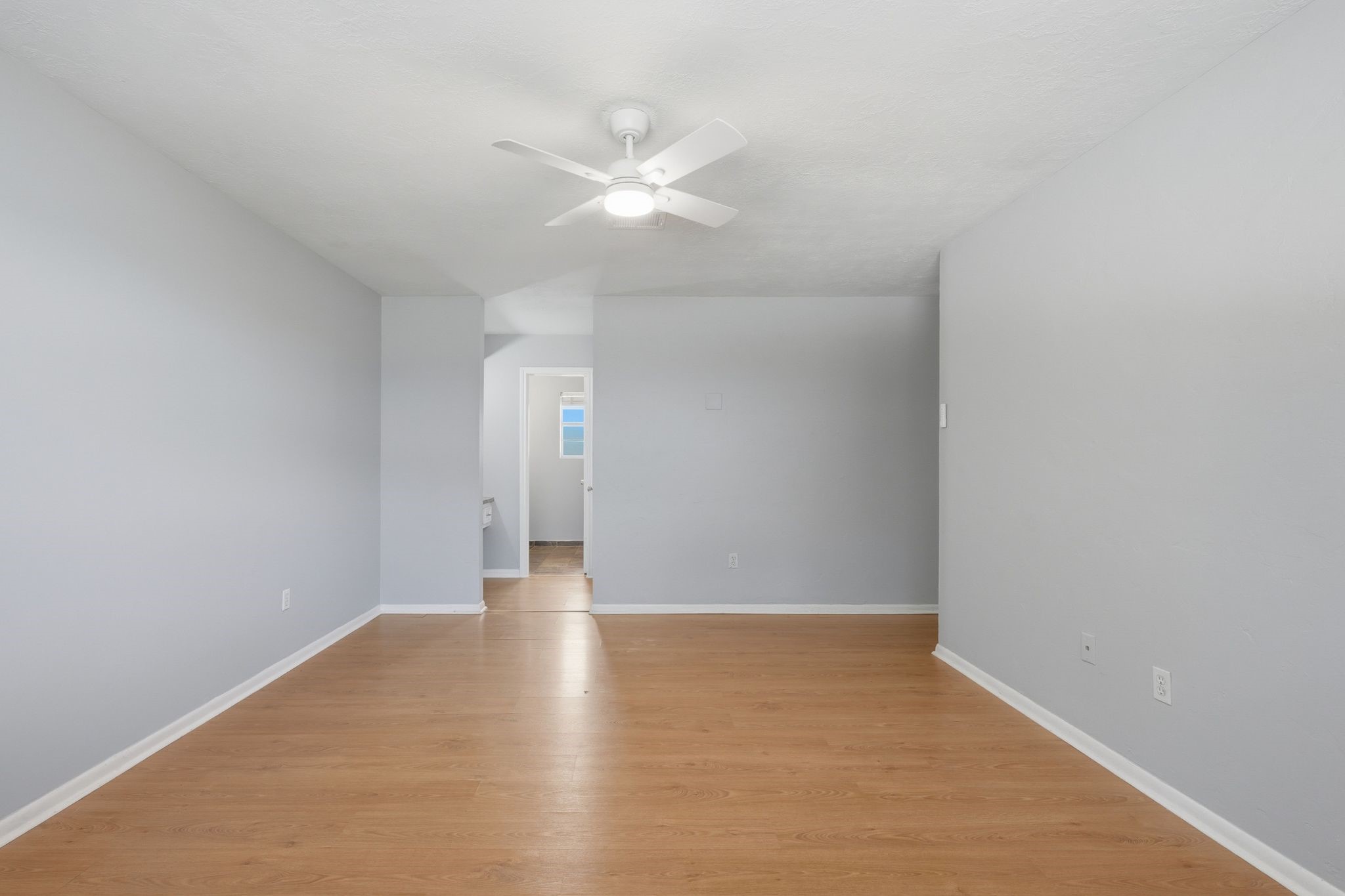 25611 Timberlane Drive Spring, TX 77386 - Photo 19 of 38 a view of an empty room with wooden floor and a ceiling fan