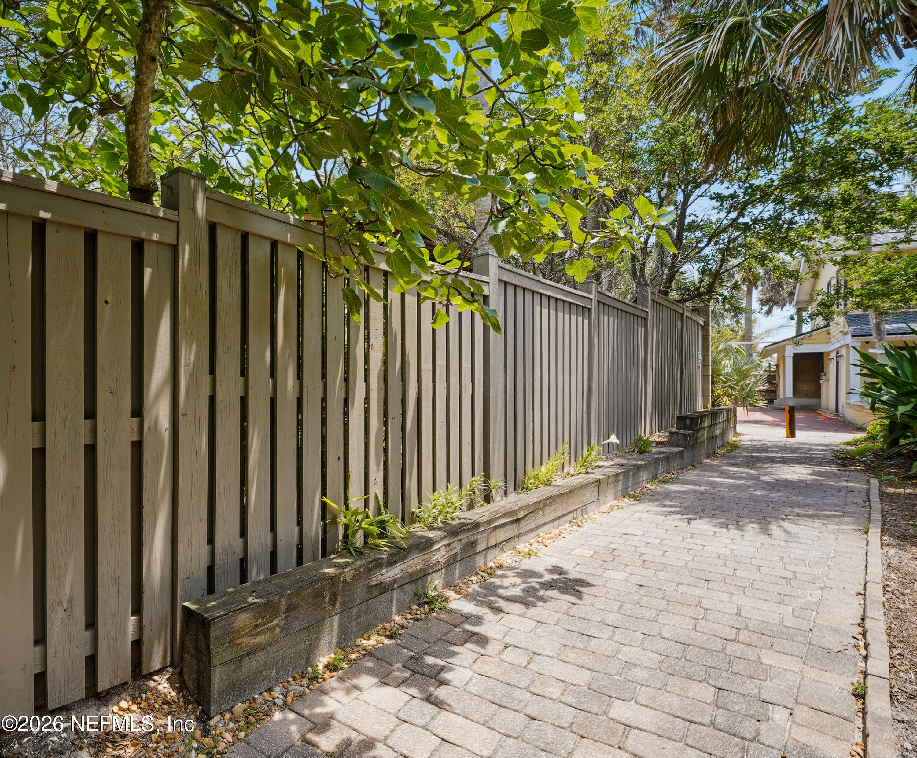 1890 Beachside Court Atlantic Beach, FL 32233 - Photo 39 of 41 a backyard of a house with lawn chairs and wooden fence