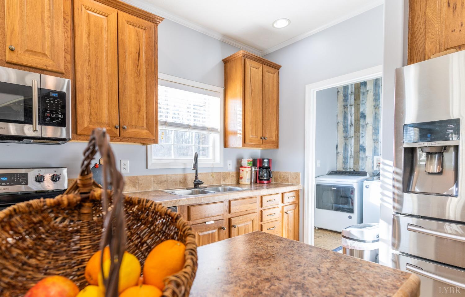 2659 Chilton Road Appomattox, VA 24522 - Photo 18 of 55 a kitchen with stainless steel appliances granite countertop a stove a sink and a microwave