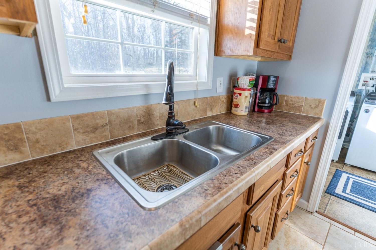 2659 Chilton Road Appomattox, VA 24522 - Photo 19 of 55 a kitchen with a sink a counter top space and cabinets