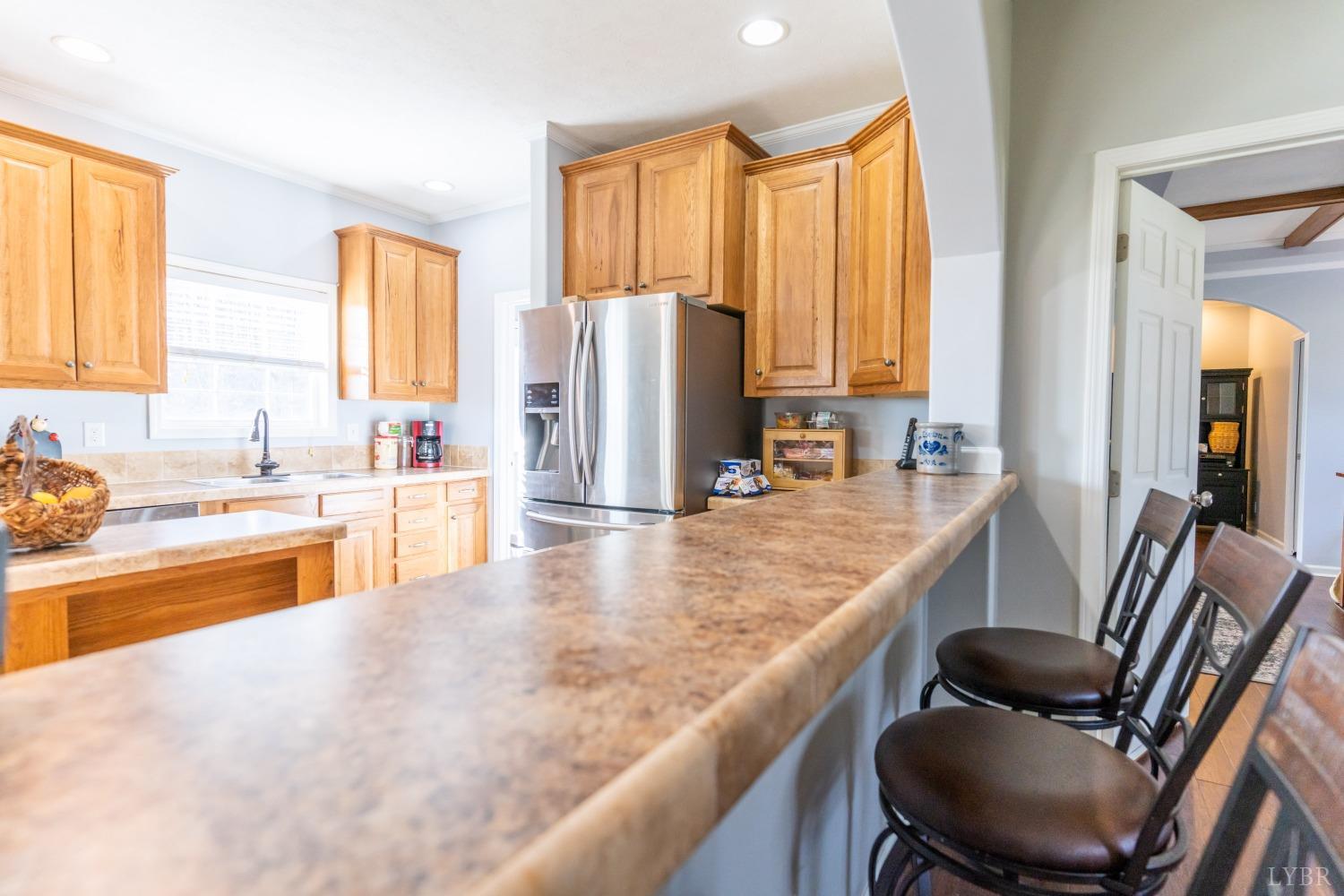 2659 Chilton Road Appomattox, VA 24522 - Photo 21 of 55 a kitchen with kitchen island granite countertop a sink and a refrigerator