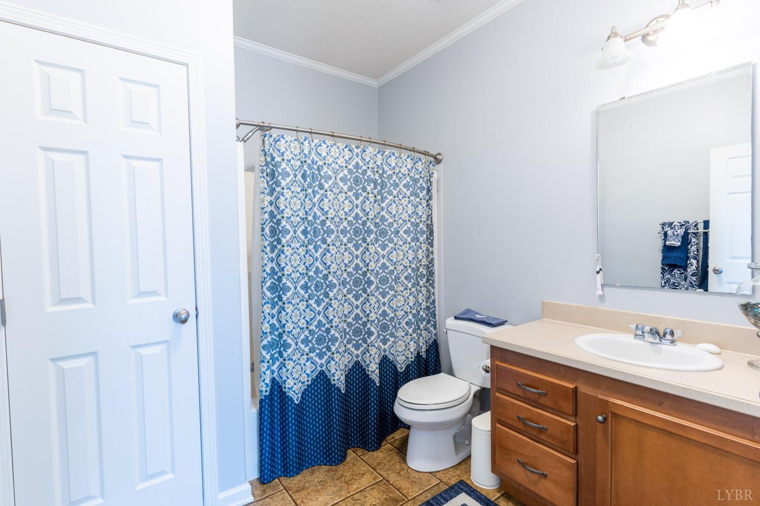 2659 Chilton Road Appomattox, VA 24522 - Photo 25 of 55 a bathroom with a granite countertop sink toilet and shower
