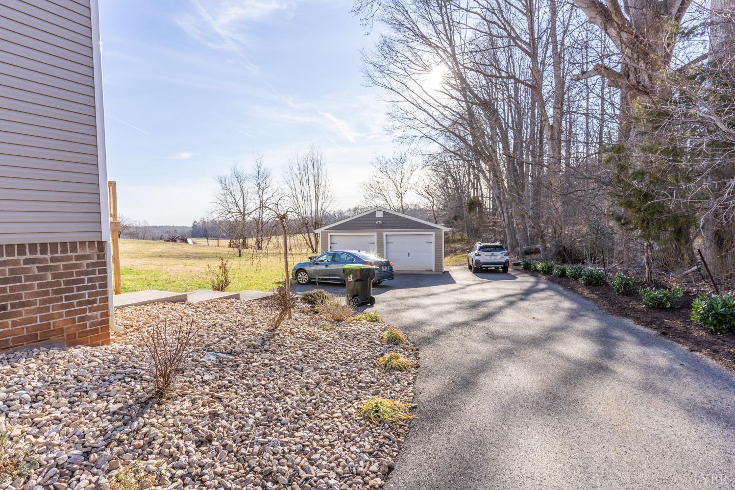 2659 Chilton Road Appomattox, VA 24522 - Photo 45 of 55 a view of a lake with a bench and trees around