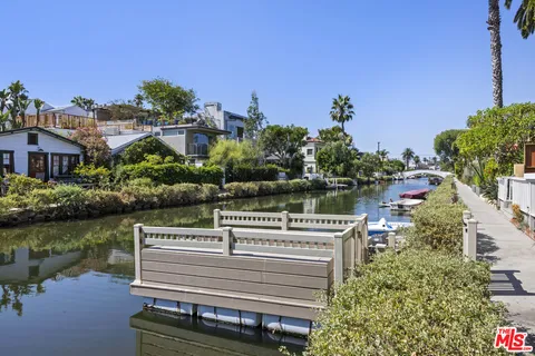 a view of a lake with palm trees