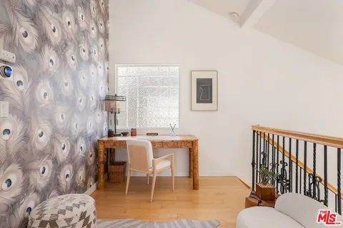 a dining room with furniture and wooden floor