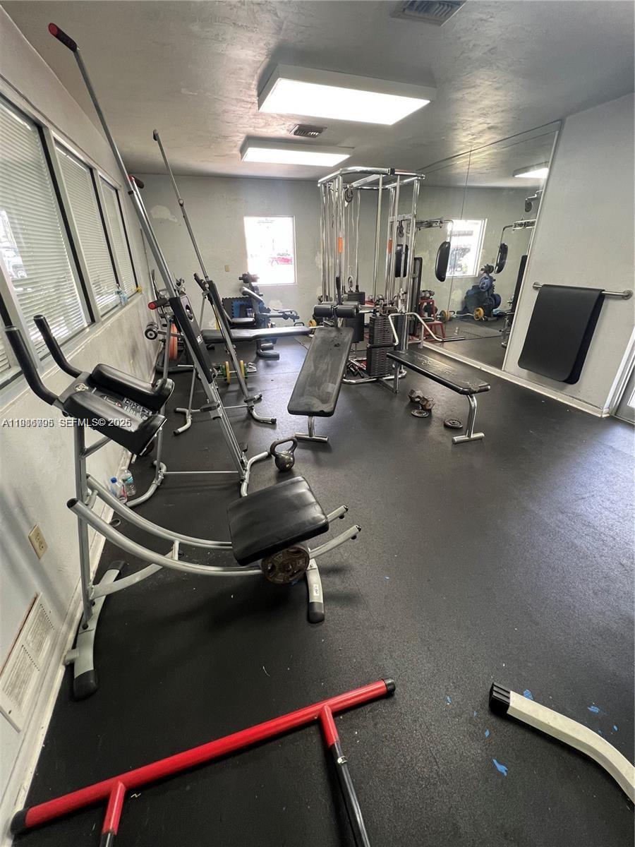 8307 Southwest 142nd Avenue, Unit F105 Miami, FL 33183 - Photo 18 of 19 a room with gym equipment