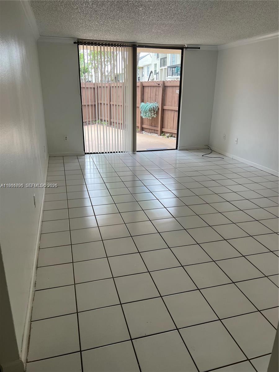8307 Southwest 142nd Avenue, Unit F105 Miami, FL 33183 - Photo 4 of 19 a view of an empty room and a window