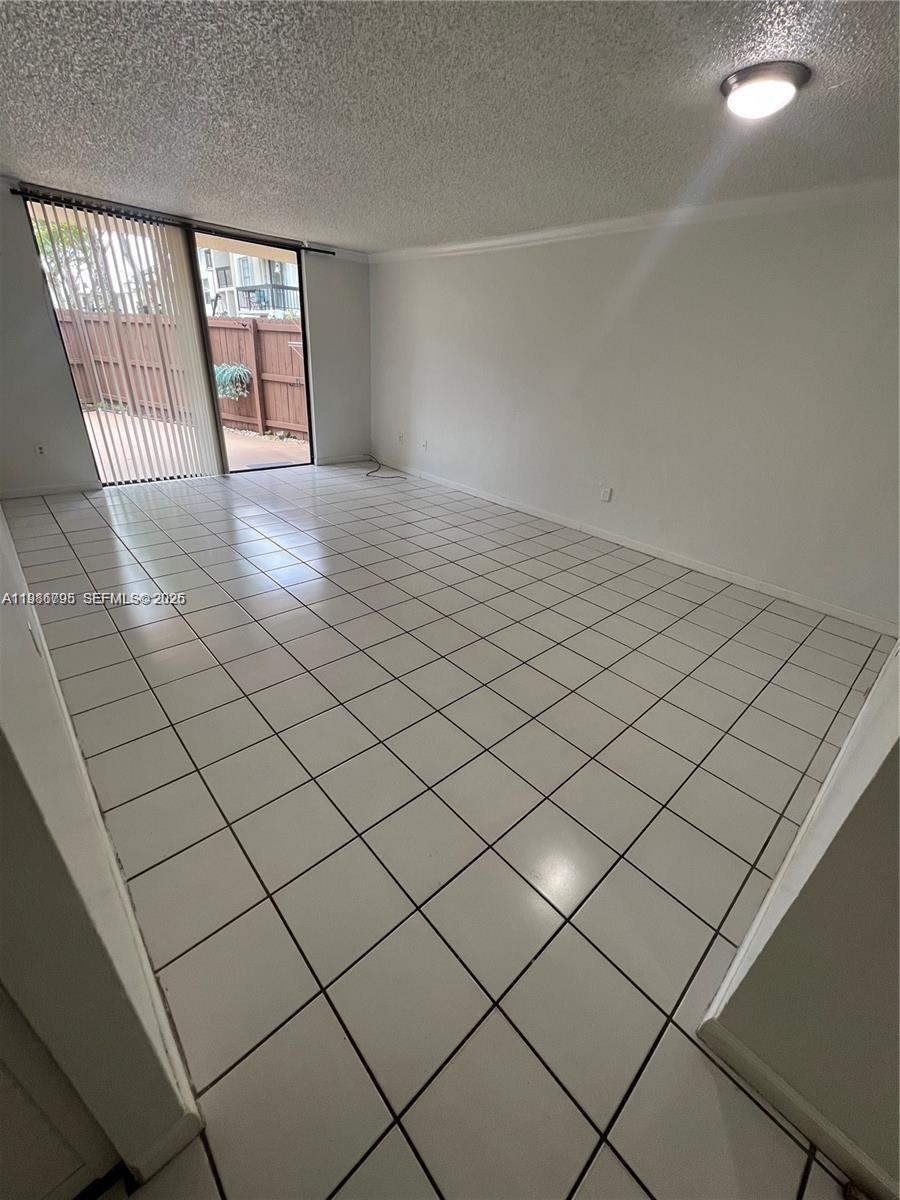 8307 Southwest 142nd Avenue, Unit F105 Miami, FL 33183 - Photo 5 of 19 an empty room with windows