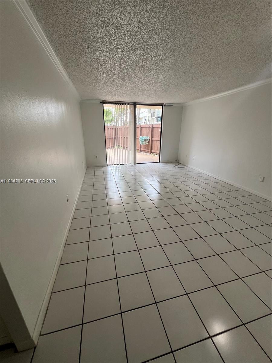 8307 Southwest 142nd Avenue, Unit F105 Miami, FL 33183 - Photo 9 of 19 a view of an empty room and window