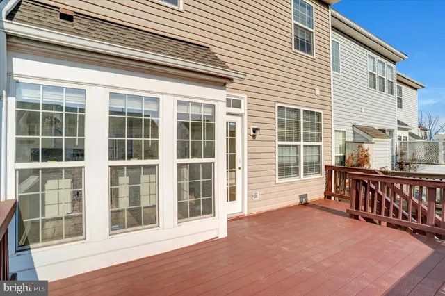 an empty room with windows and ceiling fan