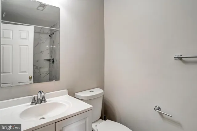 a view of an empty room with a window and fireplace