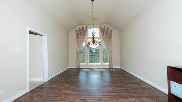 a view of a livingroom with furniture wooden floor fireplace