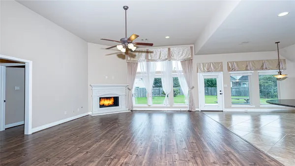 a view of an empty room with a fireplace and a window