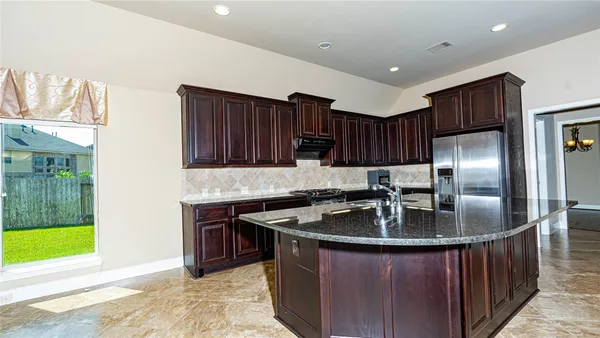 a view of a kitchen with a sink and a window