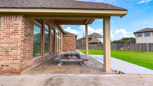 a view of a house with backyard sitting area and garden