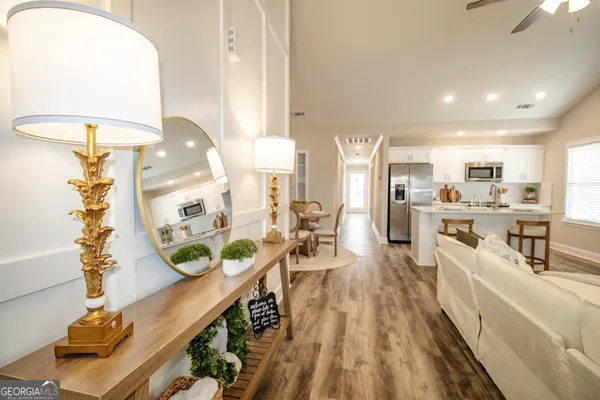 a very nice looking open dining room with kitchen island