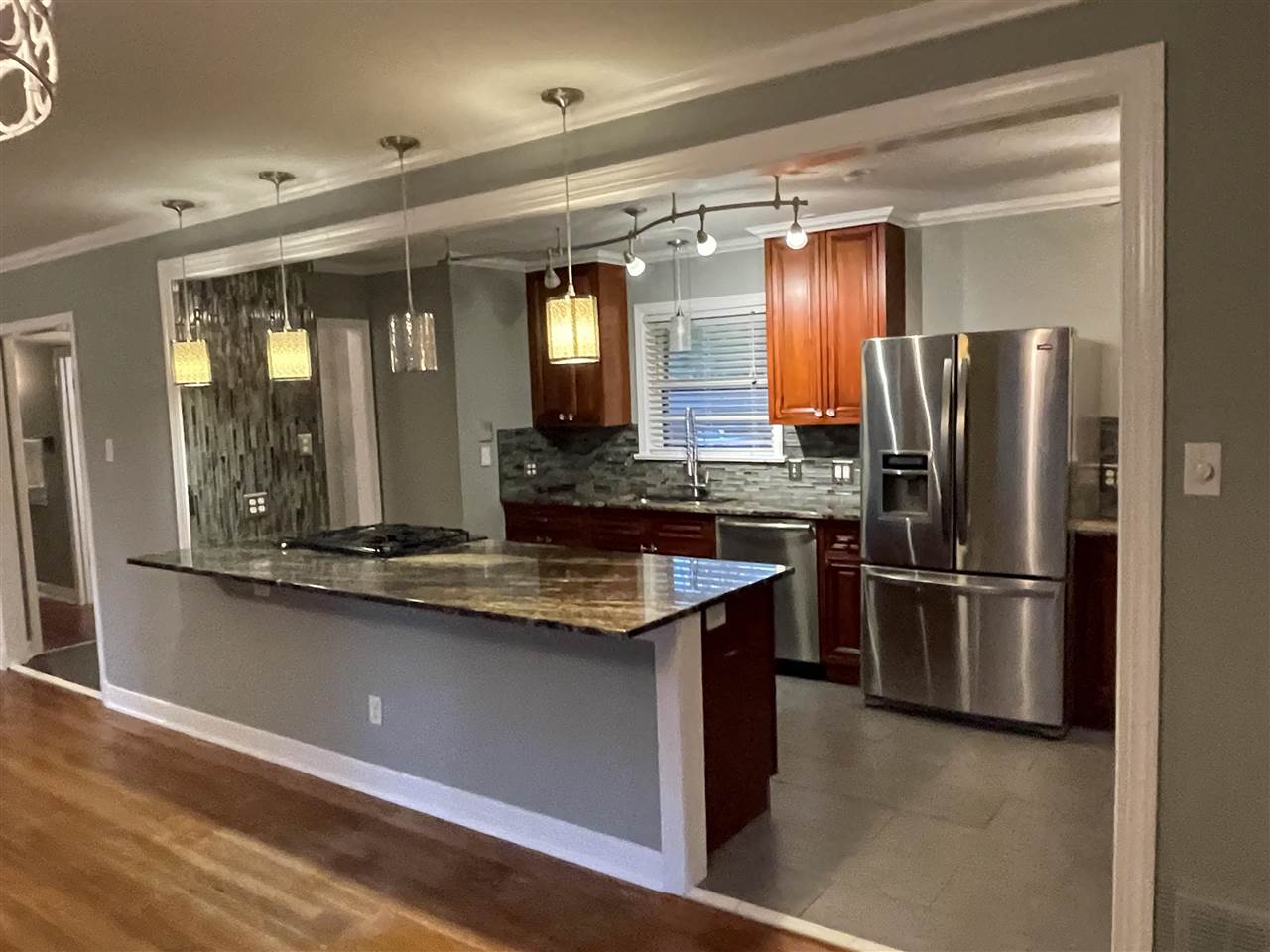 4294 Chickasaw Road Memphis, TN 38117 - Photo 13 of 15 a kitchen with stainless steel appliances granite countertop a refrigerator and a sink