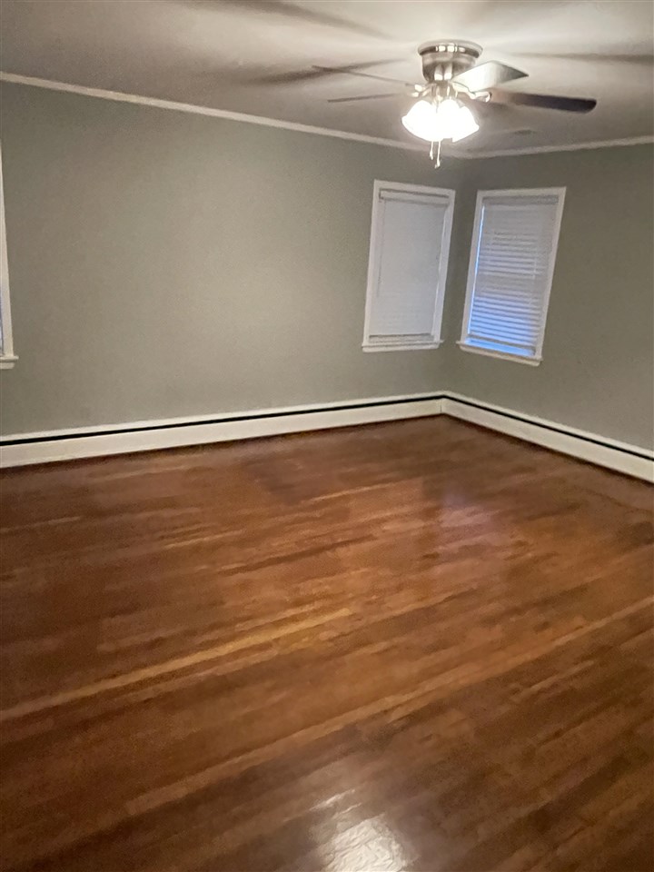 4294 Chickasaw Road Memphis, TN 38117 - Photo 7 of 15 a view of a room with an empty space and a ceiling fan