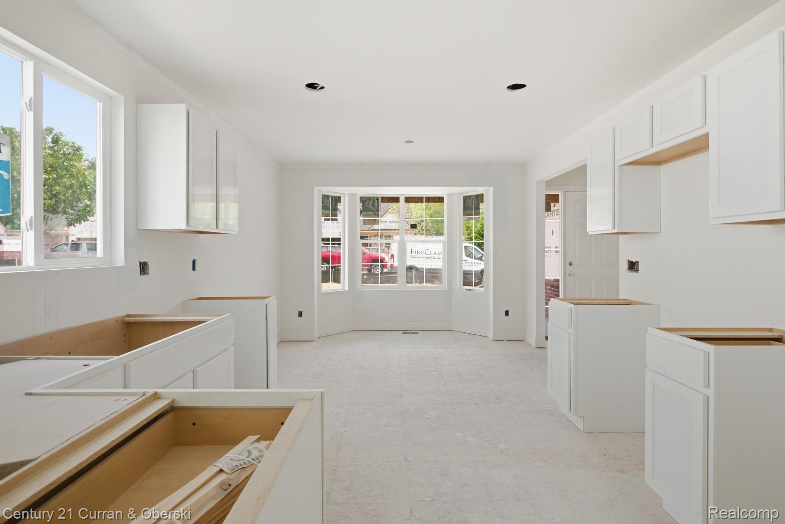 823 Nelson's Ridge Drive, Unit 13 Howell, MI 48843 - Photo 14 of 30 Spacious kitchen featuring white shaker-style cabinetry, recessed lighting, and a bay window