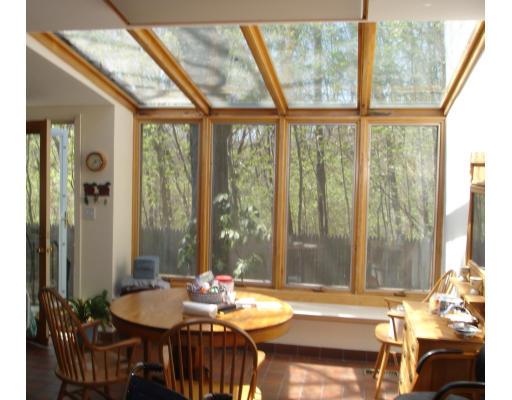 5 Beverly Road Newton, MA 02461 - Photo 4 of 8 a view of a dining room with furniture large windows and wooden floor