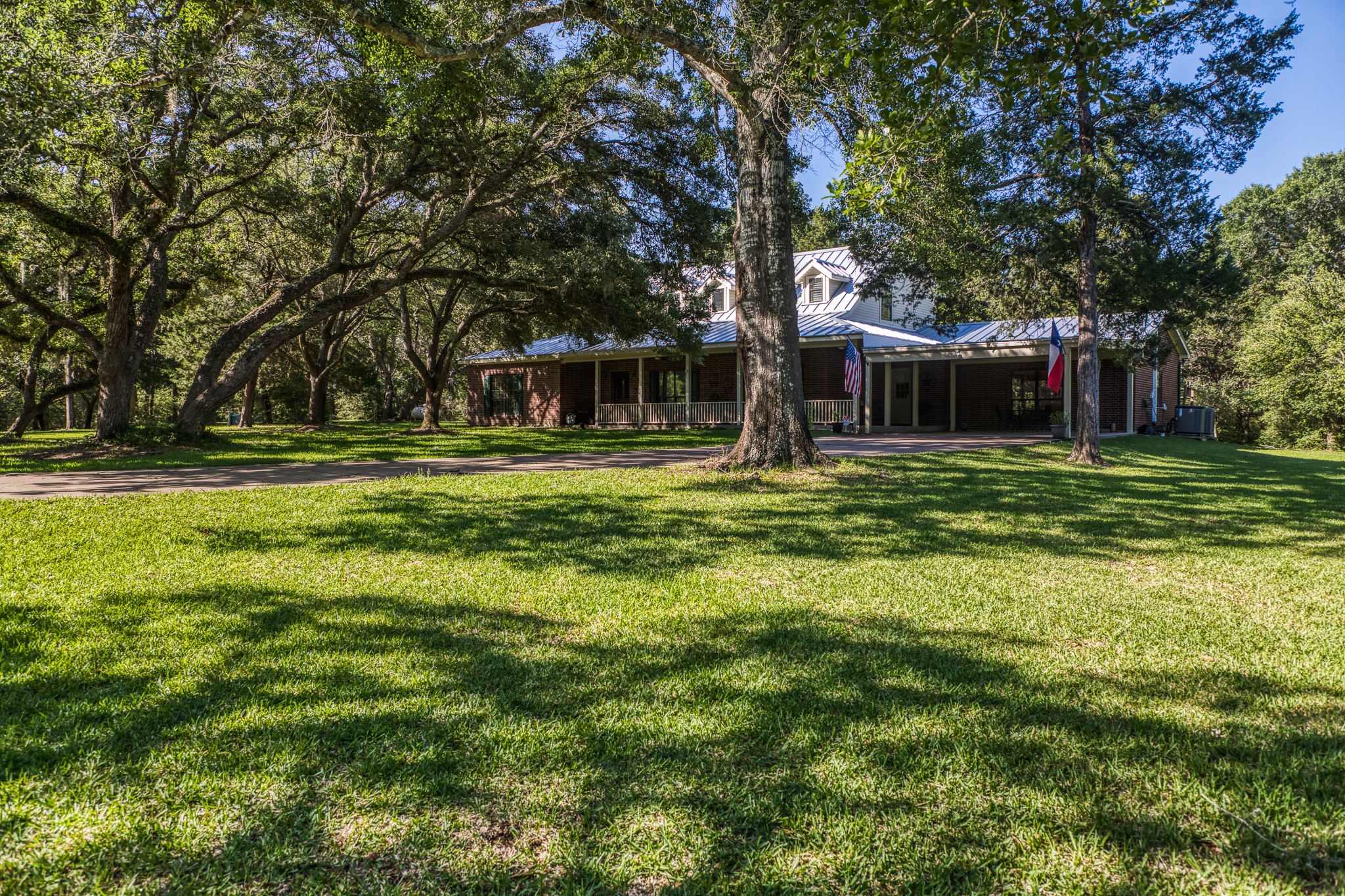 1017 Allen Road Cat Spring, TX 78933 - Photo 1 of 47 a backyard of a house with lots of green space and fountain