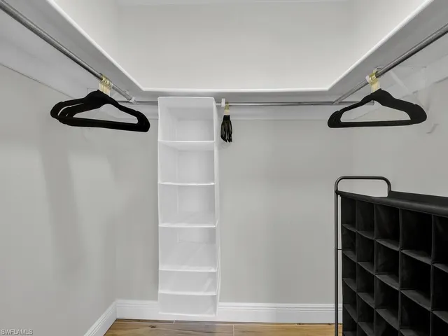 a view of walk in closet with empty racks