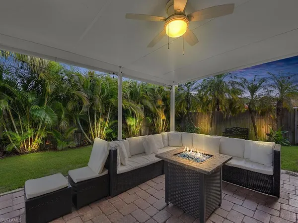 a living room with patio furniture and garden