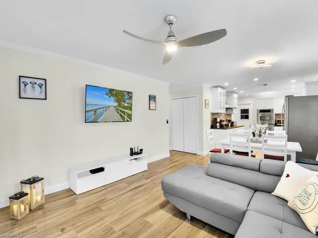 a living room with furniture and kitchen view