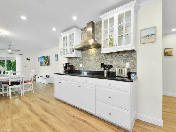 a kitchen with stainless steel appliances granite countertop a sink and cabinets