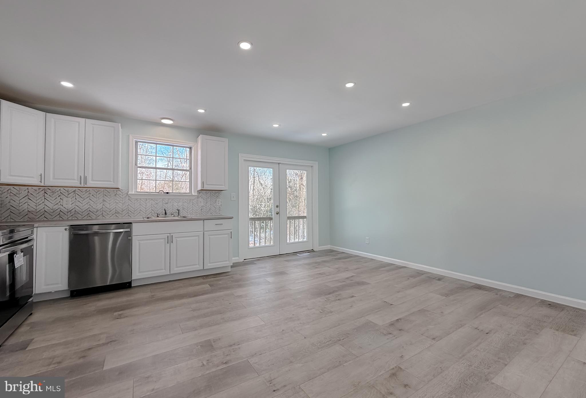 470 Sollers Wharf Road Lusby, MD 20657 - Photo 11 of 43 a view of an empty room with a kitchen and window
