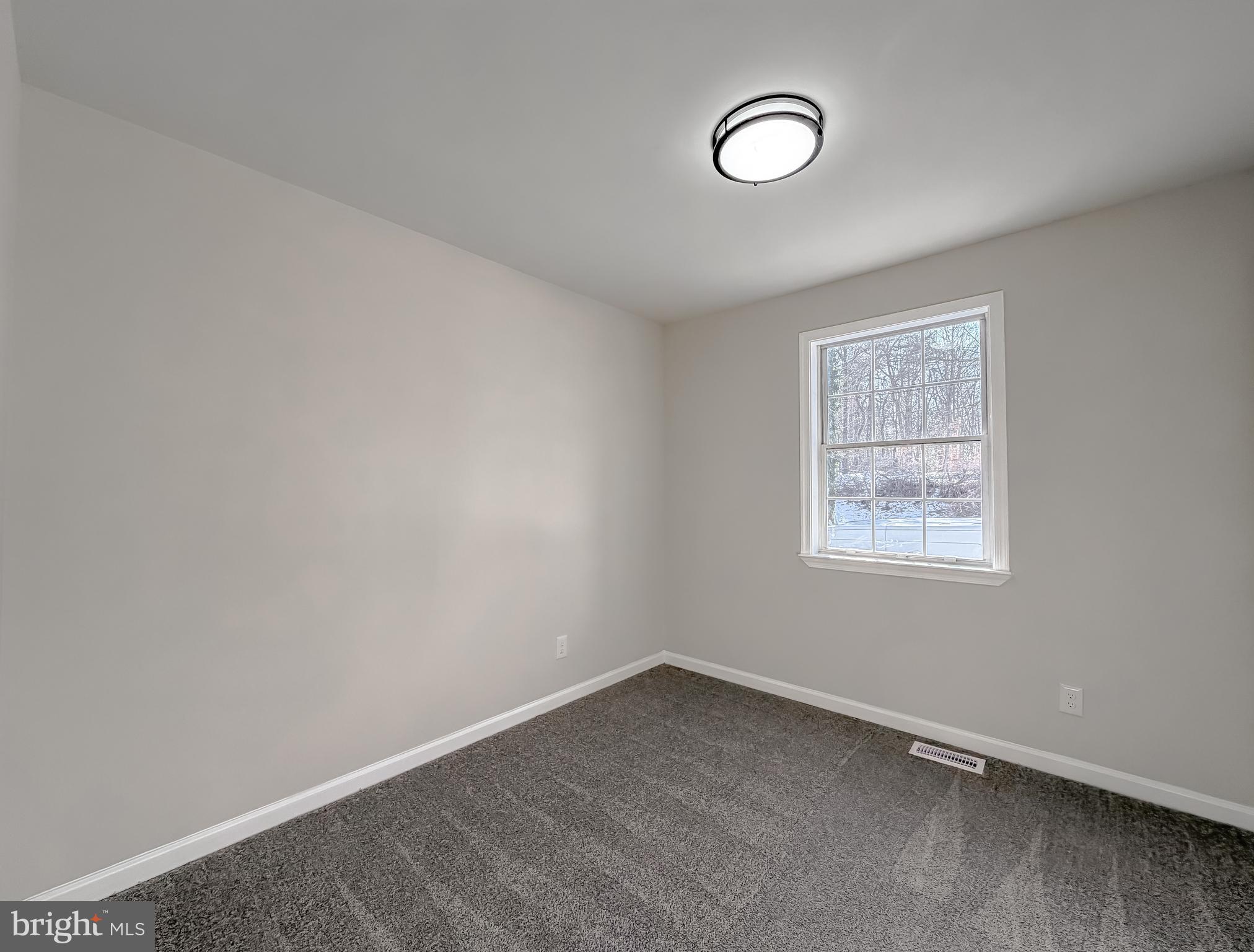 470 Sollers Wharf Road Lusby, MD 20657 - Photo 13 of 43 an empty room with a fan and a window