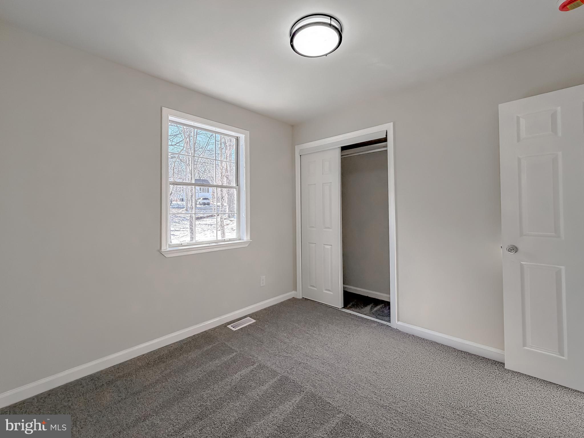 470 Sollers Wharf Road Lusby, MD 20657 - Photo 14 of 43 an empty room with windows