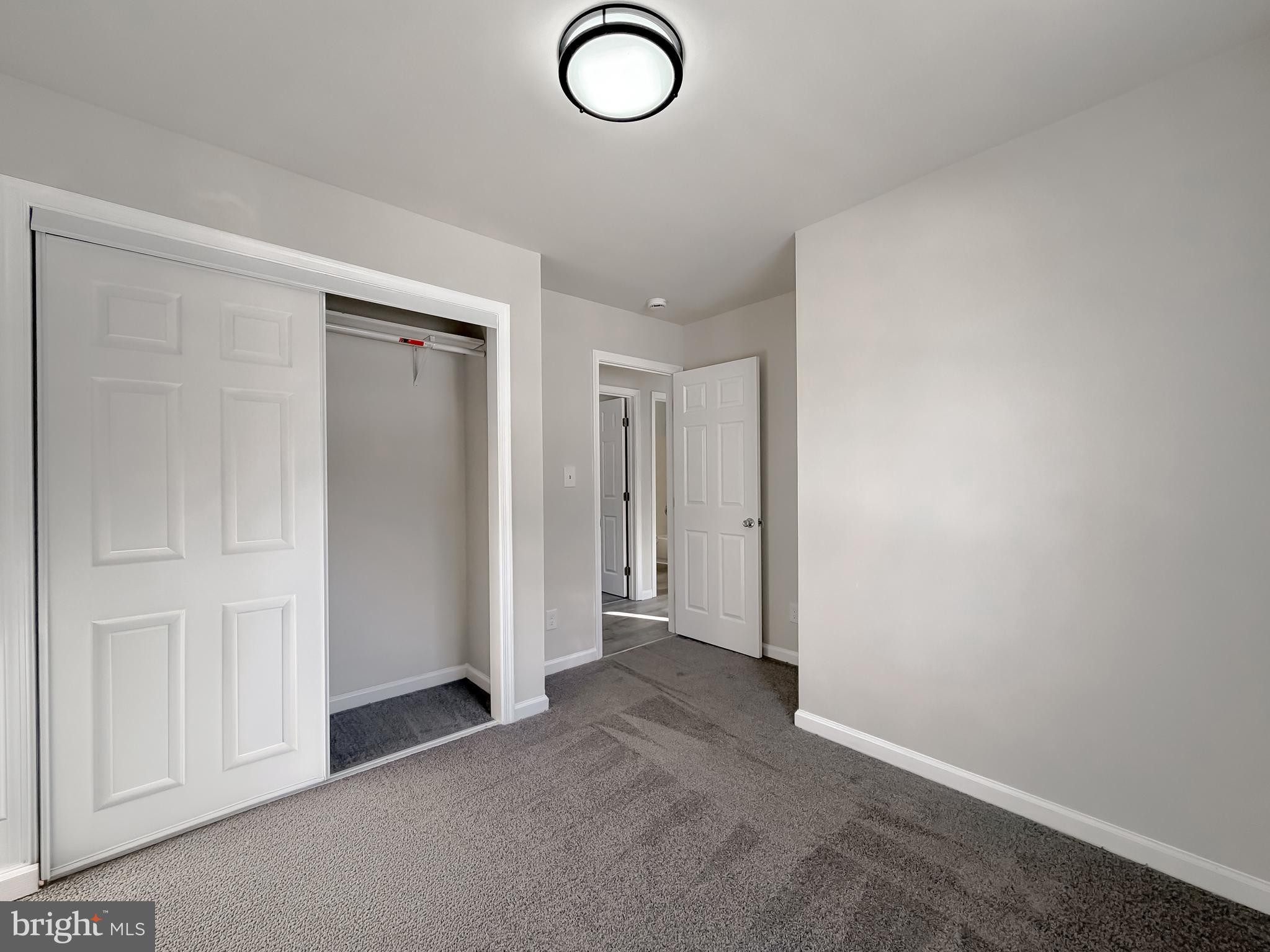 470 Sollers Wharf Road Lusby, MD 20657 - Photo 21 of 43 an empty room with closet area and glass door