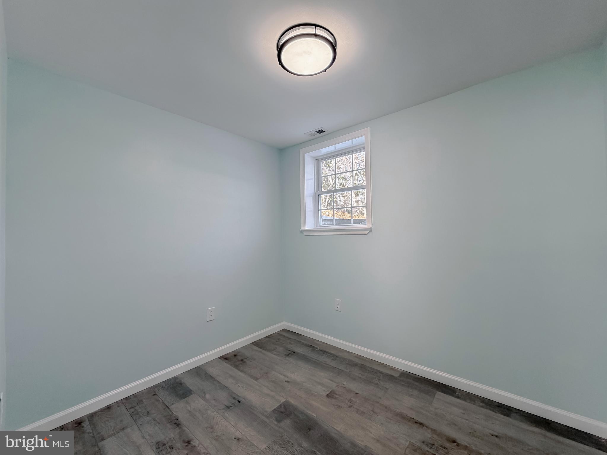 470 Sollers Wharf Road Lusby, MD 20657 - Photo 33 of 43 a view of a room with wooden floor and window