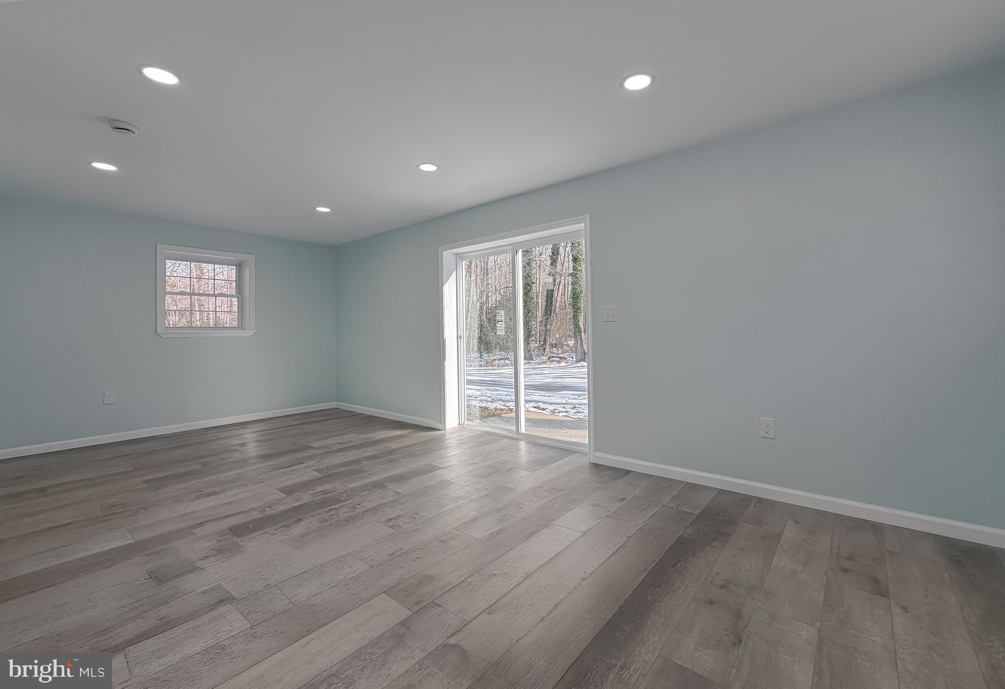 470 Sollers Wharf Road Lusby, MD 20657 - Photo 36 of 43 a view of an empty room with wooden floor and a window