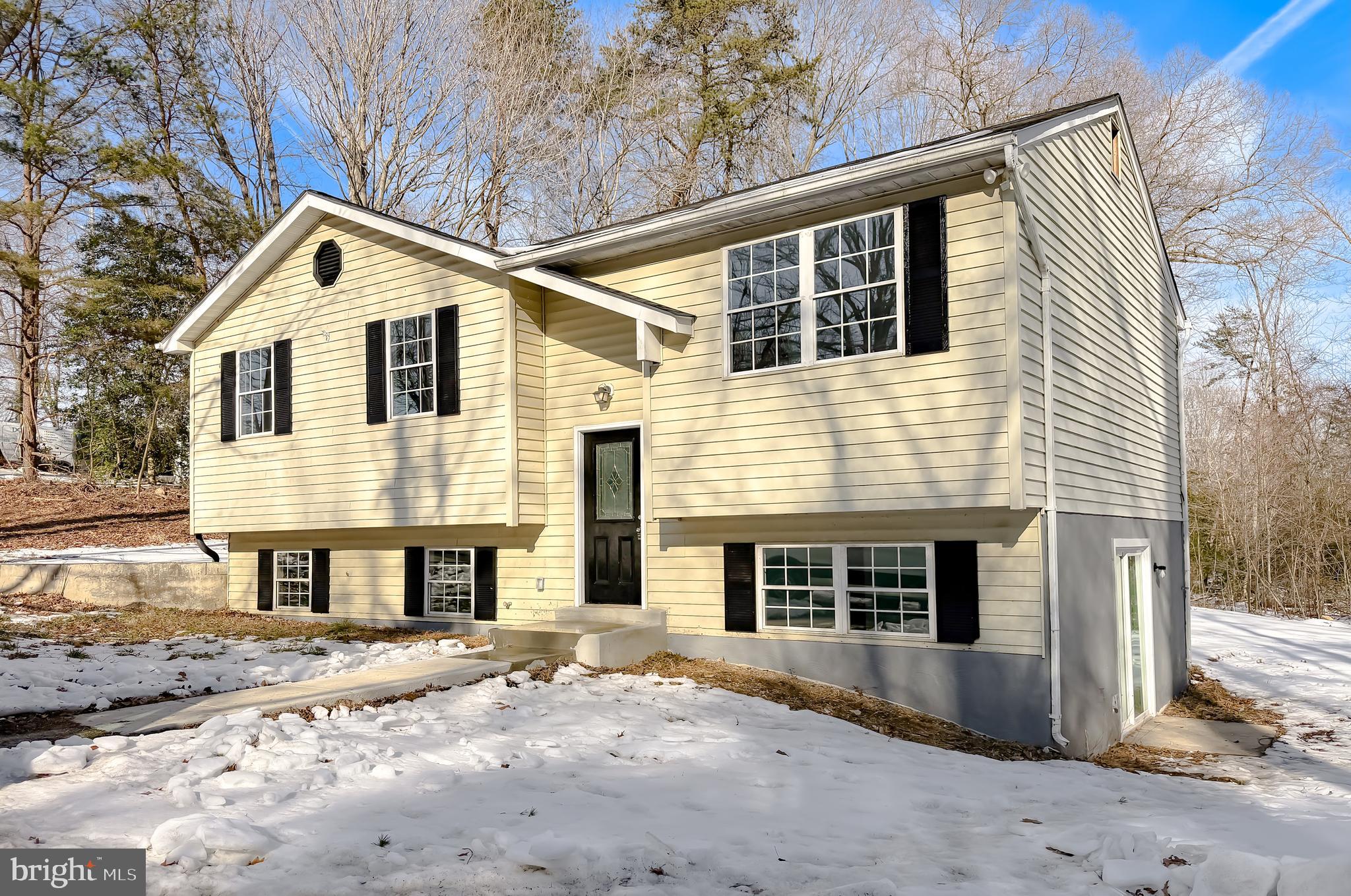470 Sollers Wharf Road Lusby, MD 20657 - Photo 42 of 43 a front view of a house with a yard and garage