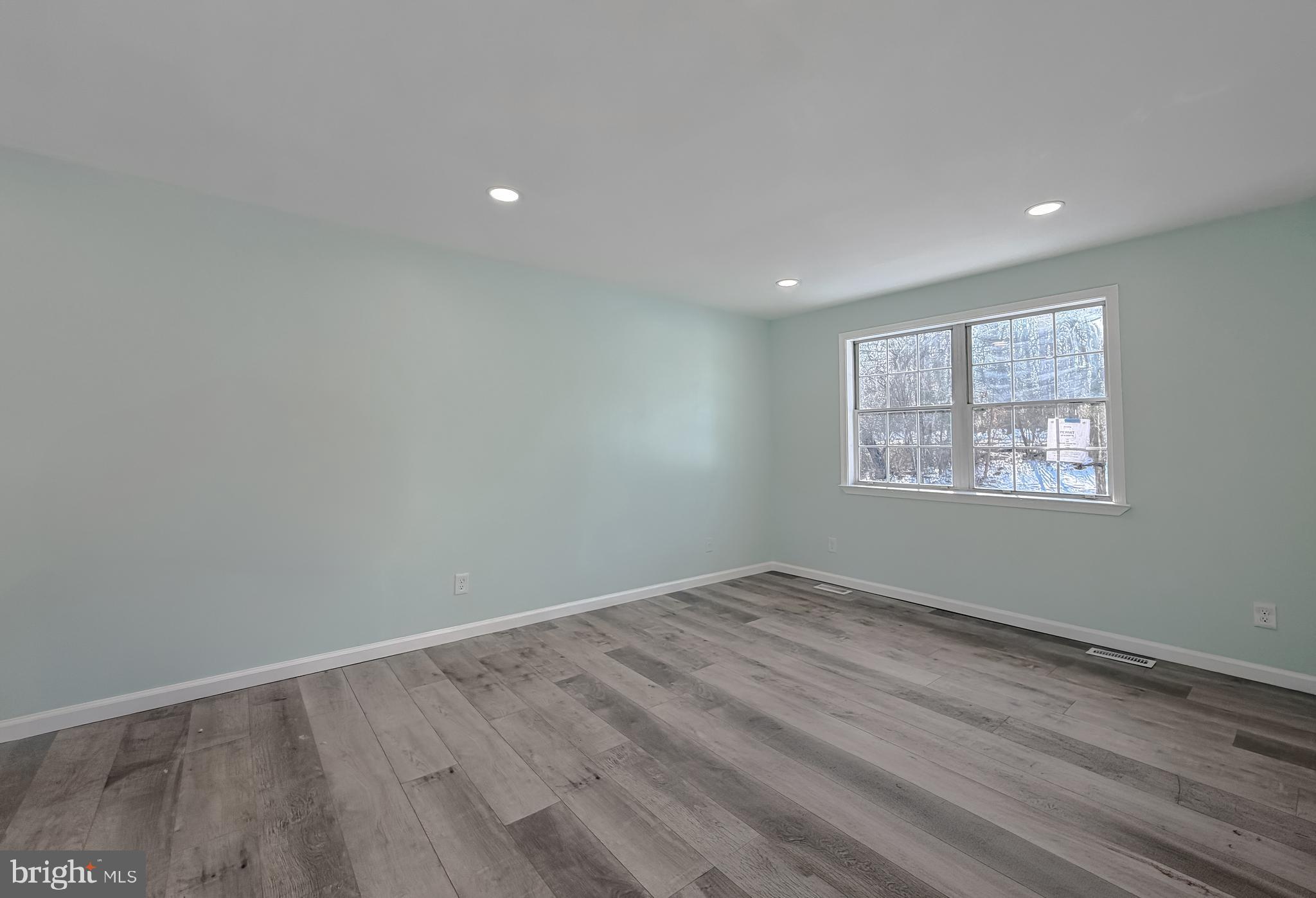 470 Sollers Wharf Road Lusby, MD 20657 - Photo 8 of 43 an empty room with wooden floor and windows