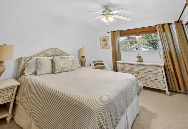 a bedroom with a large bed and a large window