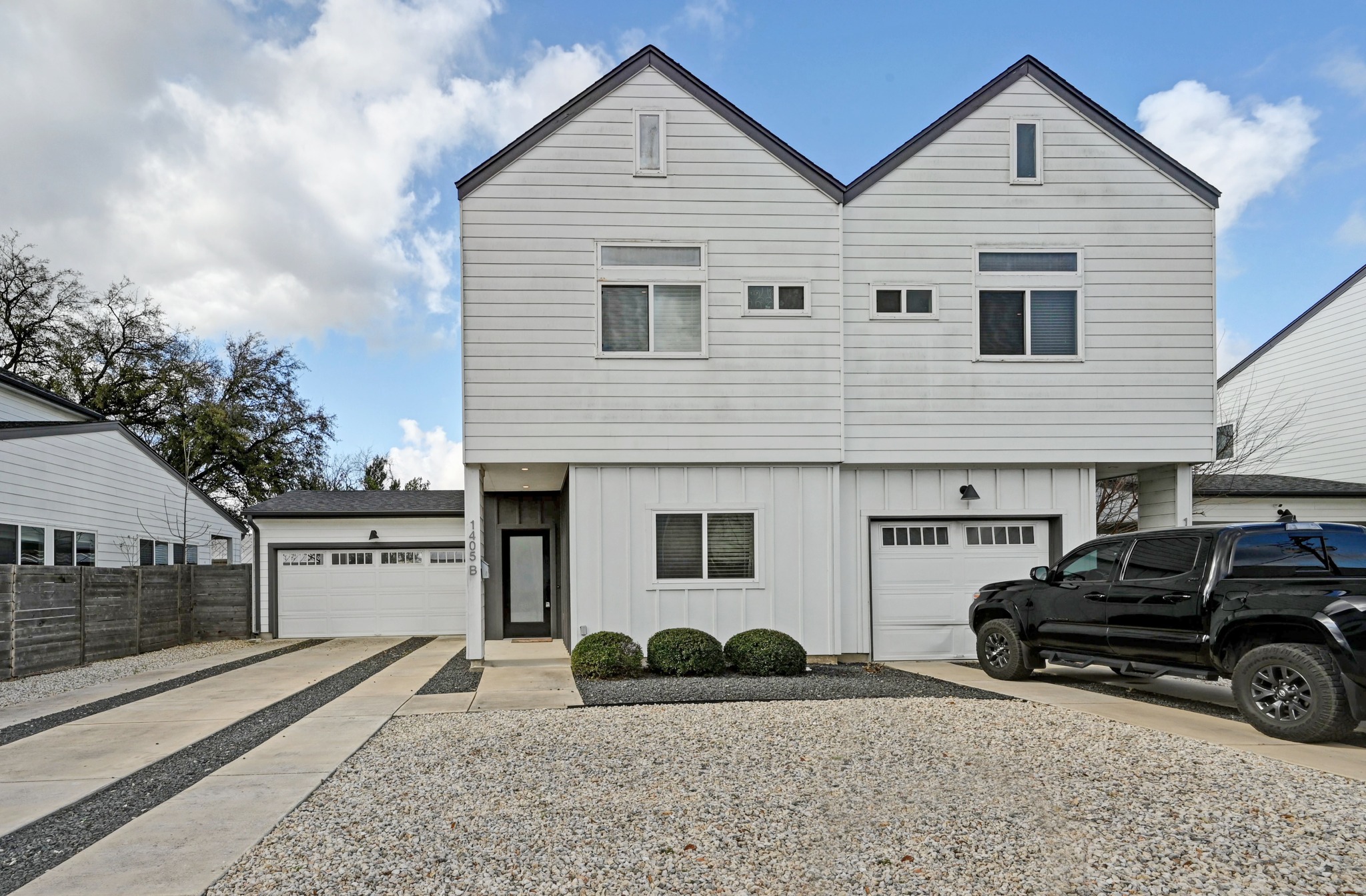 1405 Casey Street, Unit B Austin, TX 78704 - Photo 27 of 28 View of front facade with board and batten siding and concrete driveway