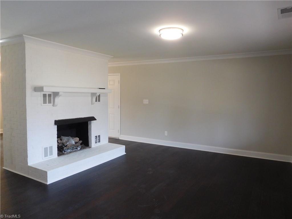 5940 Skylark Road Pfafftown, NC 27040 - Photo 3 of 42 Living Room. All New Flooring and Paint throughout. All Brick Fireplace. Fireplace is Sold As Is-No repairs. Propane FP (No Tank).