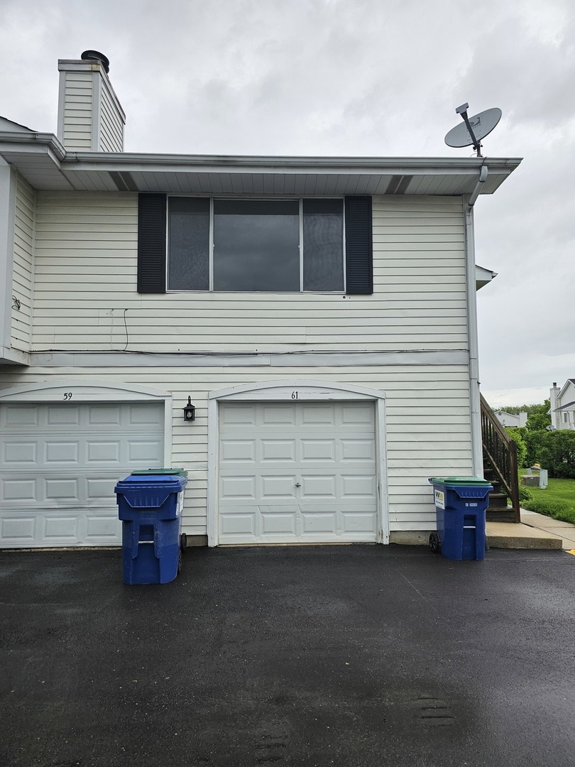 61 Red Barn Road, Unit 1 Matteson, IL 60443 - Photo 1 of 13 a couple of potted plants in front of door