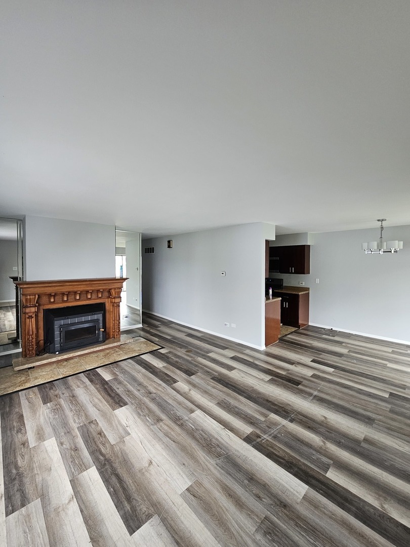 61 Red Barn Road, Unit 1 Matteson, IL 60443 - Photo 2 of 13 a view of empty room with fireplace and windows